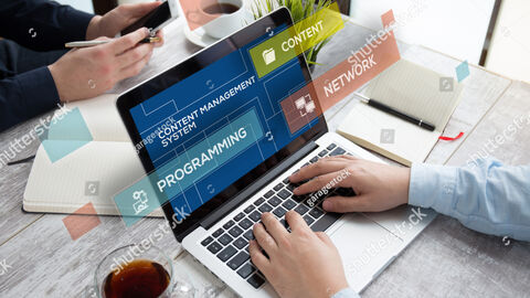 Mann am Laptop beim Arbeiten mit einem Redaktionssystem