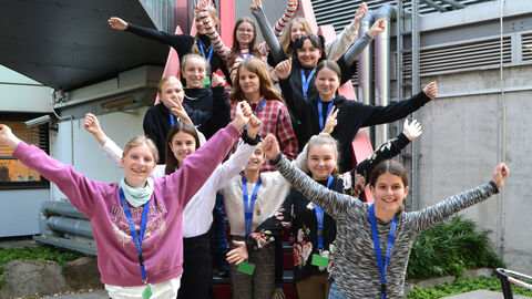 Winkende Mädchen auf der Treppe im HZD-Garten während des Girls day 2023 